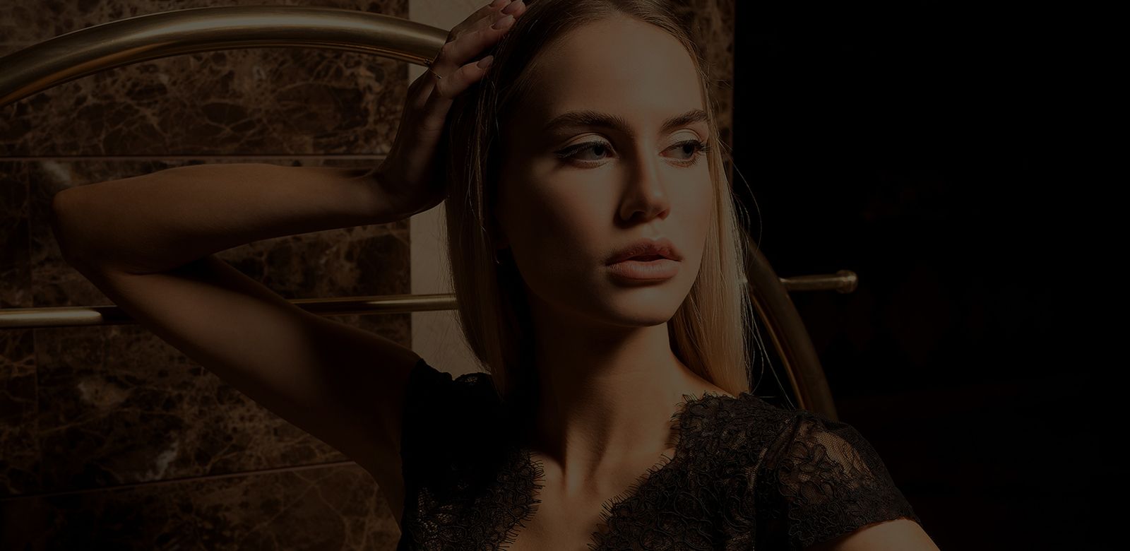 Woman with long hair in sunlit background.