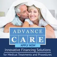 Couple under blanket promoting medical financing solutions.