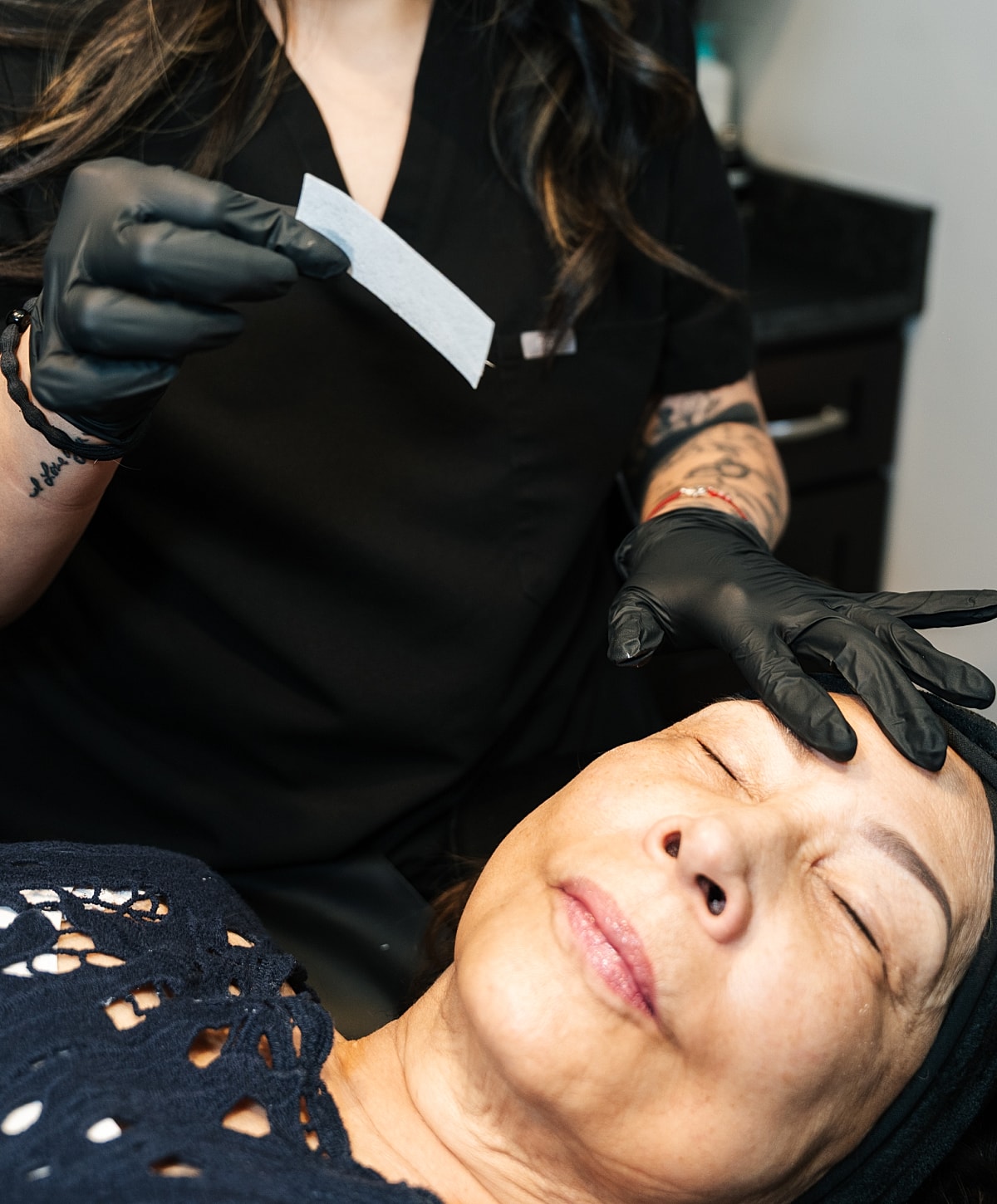 Client receiving facial treatment in beauty salon.