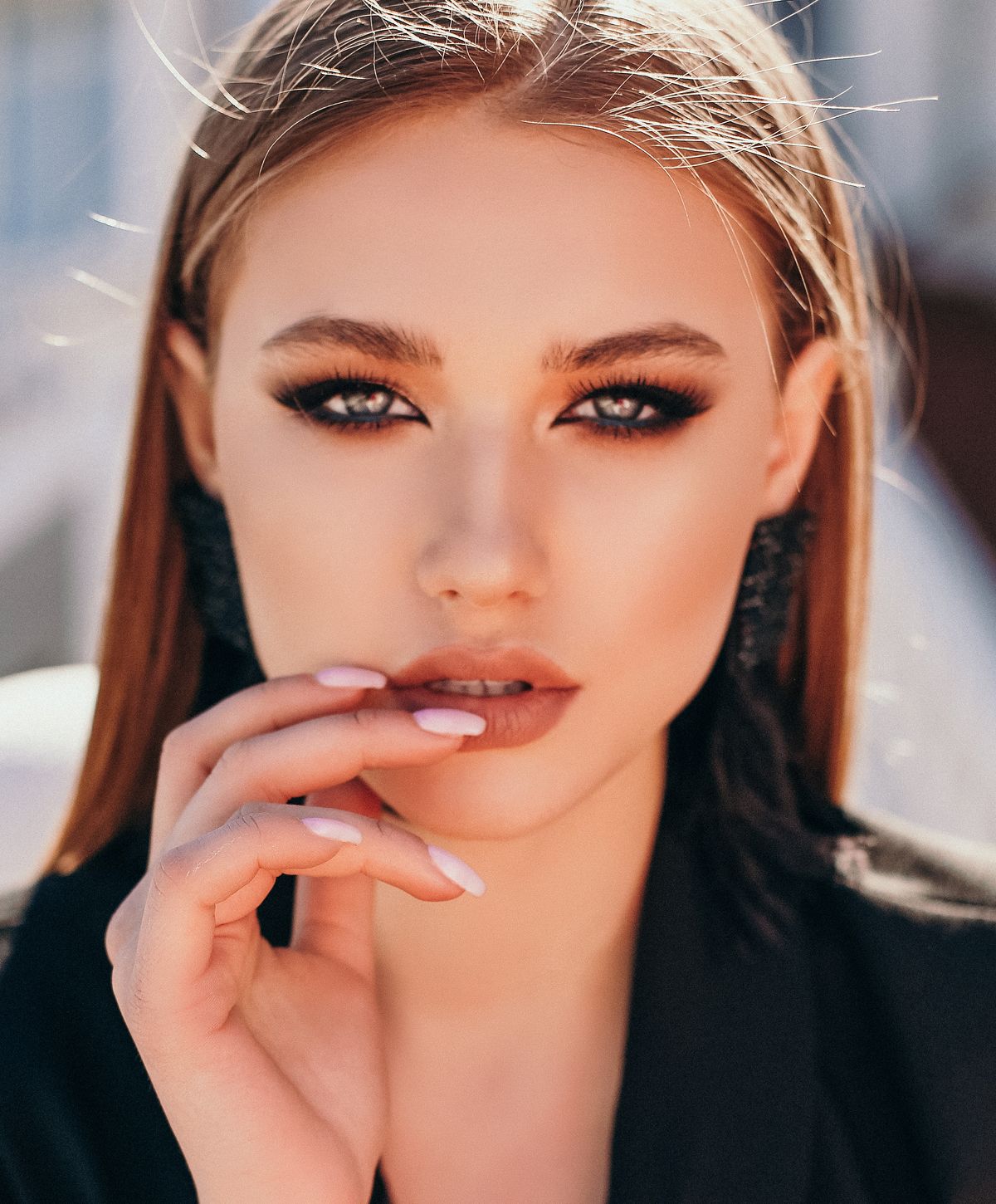 Portrait of a woman with striking makeup and expression.