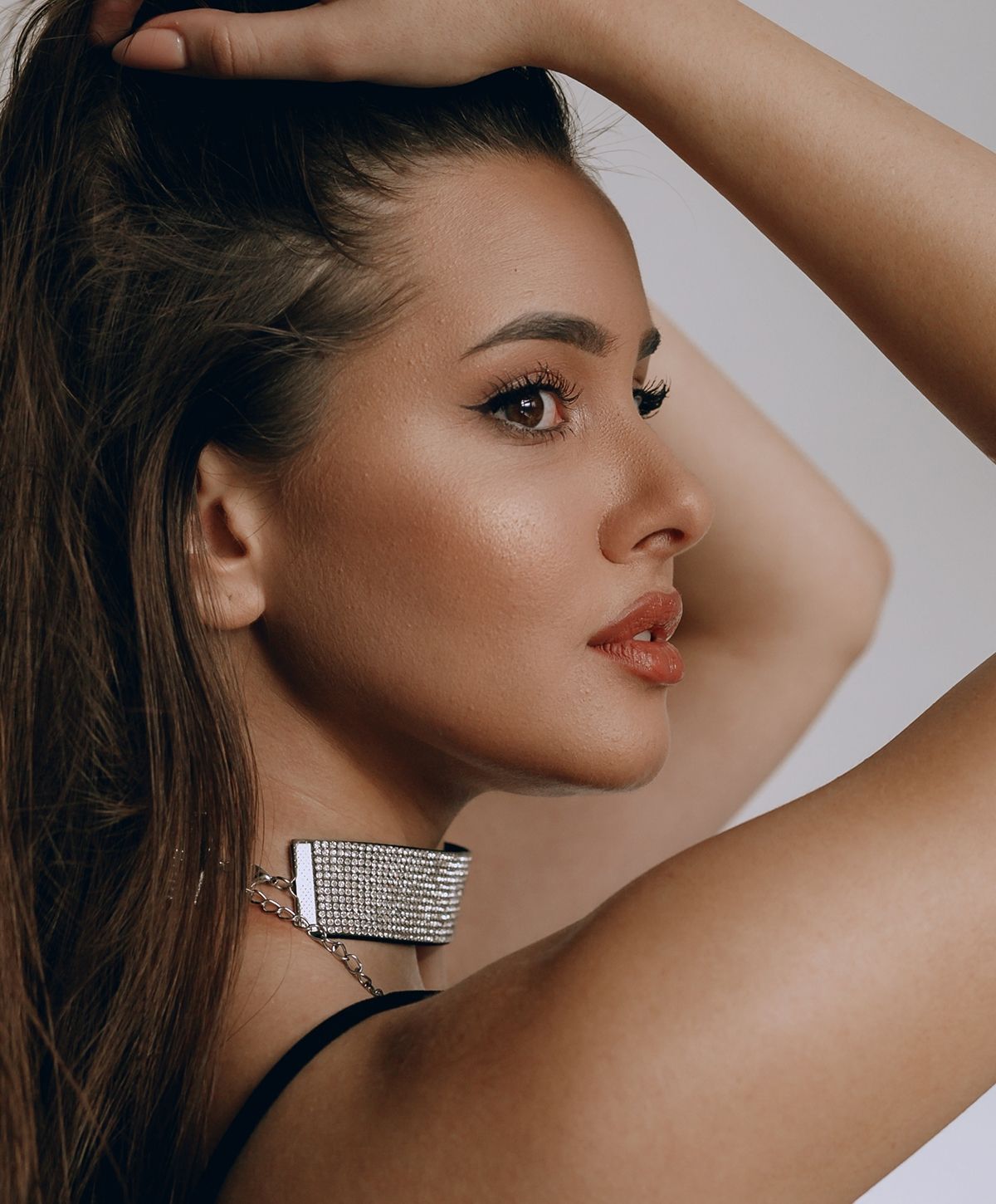 Profile of a woman with elegant jewelry.