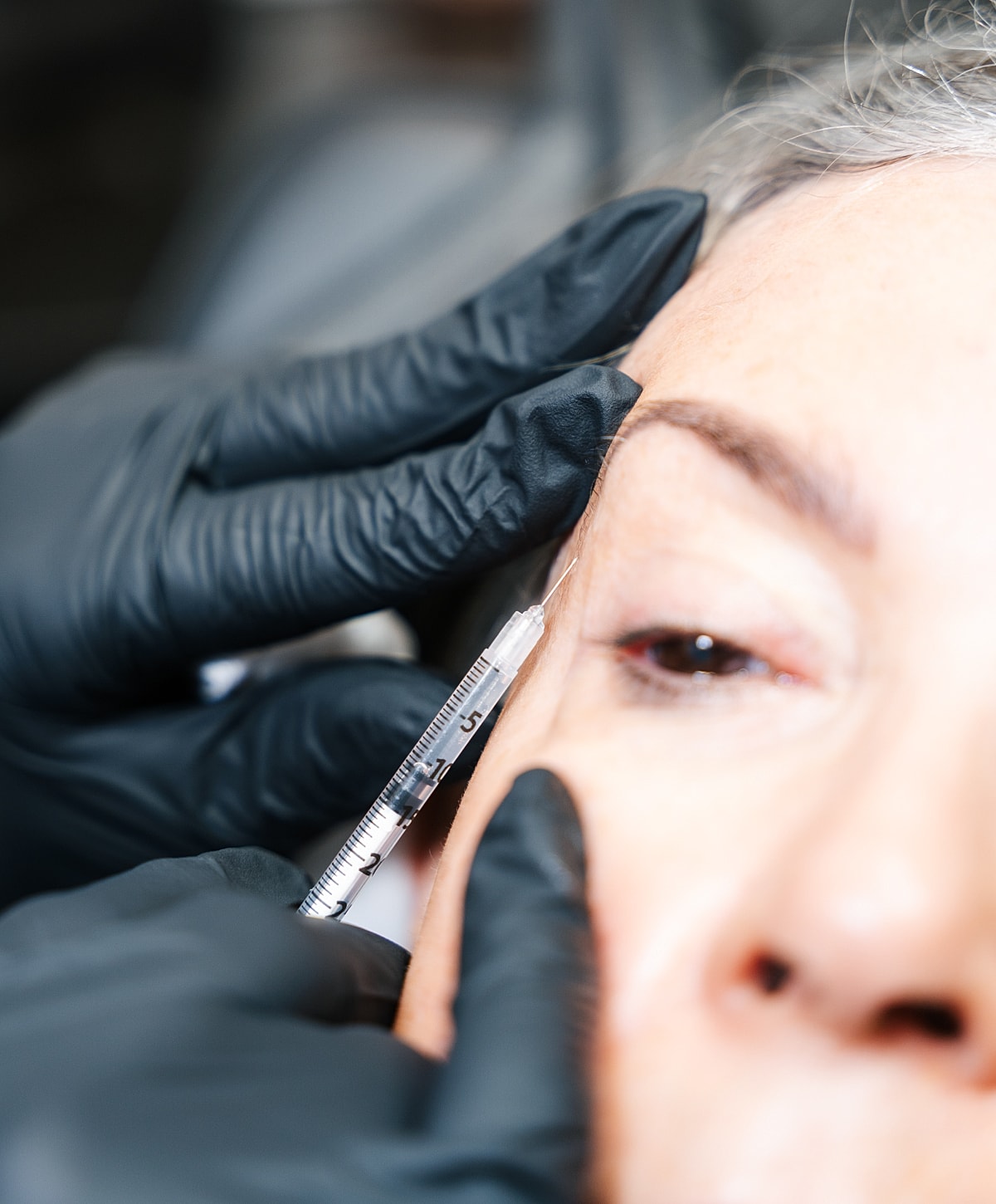 Administering a cosmetic injection treatment.
