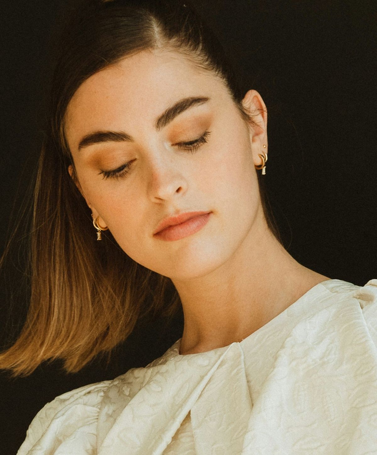 Woman in elegant blouse with natural makeup.