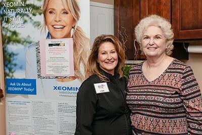 Women smiling at a Xeomin promotional event.