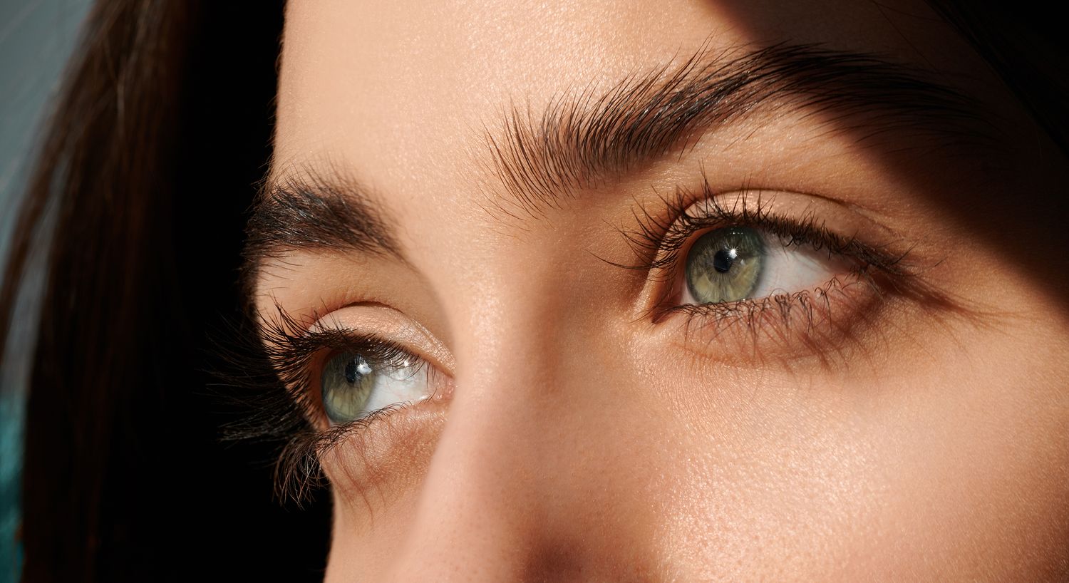 Close-up of striking green eyes and eyelashes.